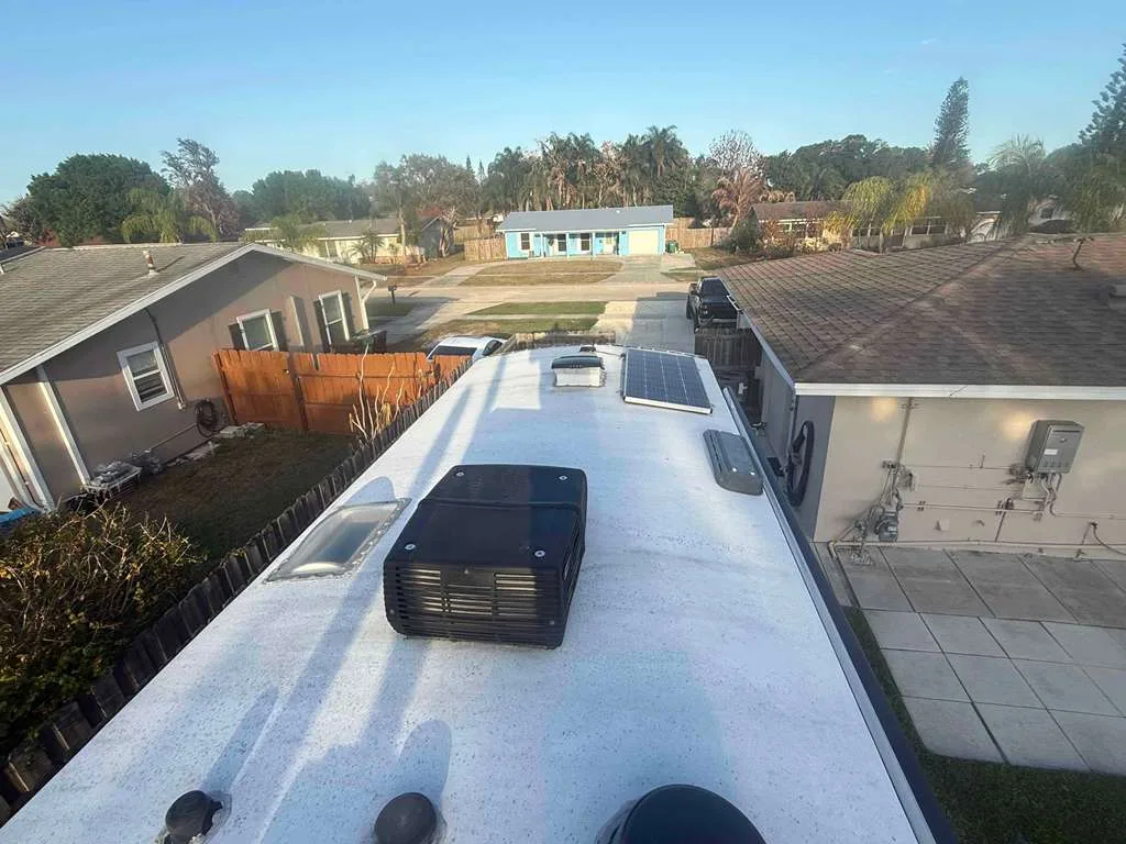 Technician replacing a rooftop AC unit on an RV in Palm City FL