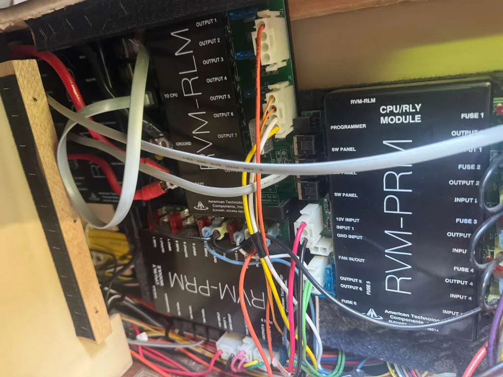 Technician repairing an RV electrical panel and shore power connection in Palm City