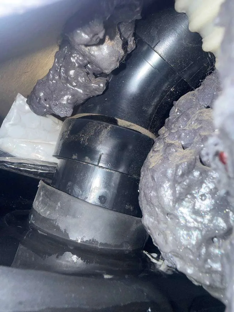 Disconnected RV black tank drain pipe during holding tank service in Palm City FL