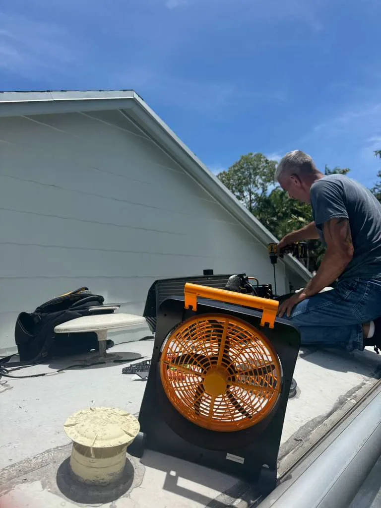 Technician working on an RV roof recoating project in Martin County FL