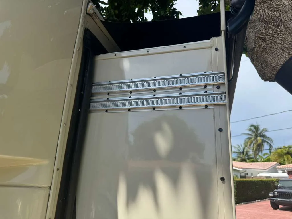 Technician repairing an RV slide out track and mechanism